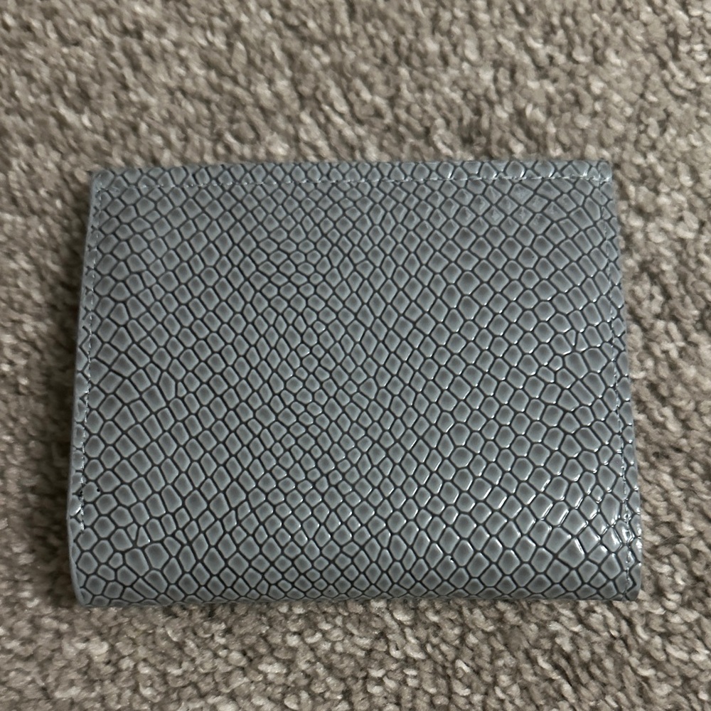 Brand new wallet, it’s gray snake skin style.